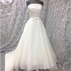 wedding dress in ivory with pink embroidery. Strapless size 14 with full organza skirt.