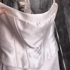 Detail of the Flamingo wedding dress neckline without the feather trim