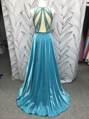 Back view of the Aften prom dress showing beaded strap detail and sheen on the skirt