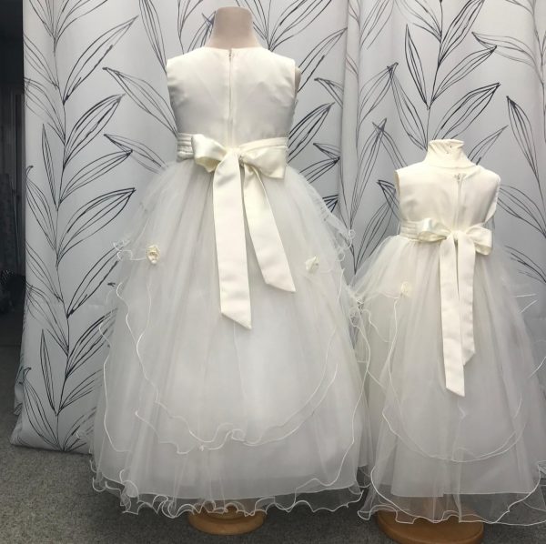 2 sizes of the same ivory flower girl dress called frost. Satin tops with tulle skirts and a satin sash which ties in a bow at the back